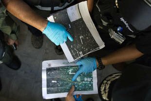 Ordnance disposal and forensic police officers investigate a grenade and gun attack at Democracy Monument in Bangkok Thursday (May 15th) that killed three. [Nicolas Asfouri/AFP]