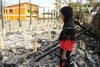 Sixth grader Waesofia Mayeetae examines the charred remains of her Islam Bumroong School in Narathiwat's Sungai Padi district on May 16th. [Rapee Mama/Khabar]