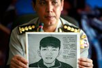 Indonesian National Police spokesman Boy Rafli Amar holds a sketch of a suspected bomb courier during a Jakarta news conference in March 2011. On May 21st, Boy announced the arrest of 10 suspected Jemaah Islamiyah members. [AFP]