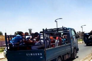 An image uploaded June 14th to a jihadist website allegedly shows Islamic State of Iraq and Syria (ISIS) militants transporting dozens of captured Iraqi security forces members to an unknown location in Salaheddin province. [AFP/Ho]