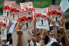 Supporters of Prabowo Subianto and Hatta Rajasa hold up fliers with their images during a June 9th debate in Jakarta. Though hard-line Islamic Defenders Front (FPI) is endorsing a coalition led by Prabowo and Hatta, campaign officials say the coalition won't accept FPI's backing. [Bay Ismoyo/AFP]