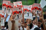 Supporters of Prabowo Subianto and Hatta Rajasa hold up fliers with their images during a June 9th debate in Jakarta. Though hard-line Islamic Defenders Front (FPI) is endorsing a coalition led by Prabowo and Hatta, campaign officials say the coalition won't accept FPI's backing. [Bay Ismoyo/AFP]