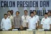 Presidential and vice presidential candidates (front, left to right) Jusuf Kalla, Joko Widodo, Prabowo Subianto and Hatta Rajasa sing the national anthem at a July 1st event in Jakarta. They were there to report their wealth, as required ahead of the July 9th presidential election. [Bay Ismoyo/AFP]