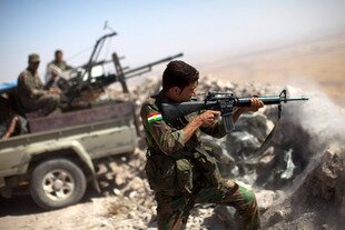  A Kurdish fighter shoots at Islamic State of Iraq and Syria (ISIS) positions from Mount Zardak, Iraq, on September 9th. Indonesian Muslims stand united in condemning ISIS violence. [JM Lopez/AFP]  