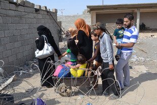  Iraqi families fleeing ISIS-perpetrated violence arrive to take refuge in a Kurdish-controlled area in Mullah Abdullah, Iraq, on October 15th. [Marwan Ibrahim/AFP] 