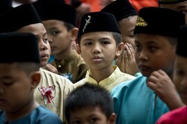  Sons of Ministry of Defence personnel arrive to take part in a mass circumcision ceremony at the Khalid al-Wahid mosque in Kuala Lumpur on Friday (December 5th). About 112 children participated in the ministry-organised event. [Manan Vatsyayana/AFP] 
